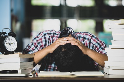 Educational conept: tired student in a library